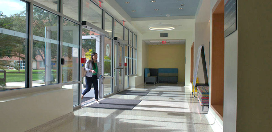 Student walking into the School of Osteopathic Medicine